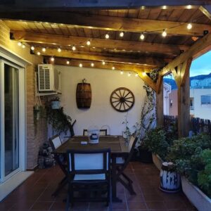 100FT Shatterproof Outdoor String Lights on patio with table